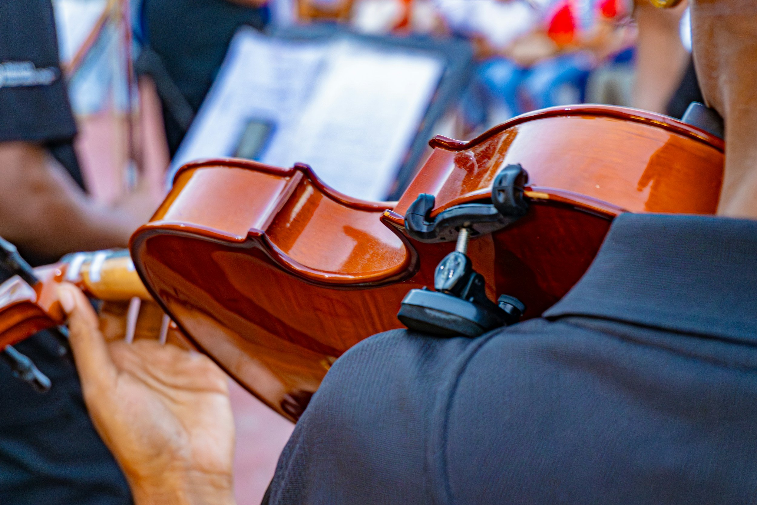 Violinist performing in outdoor setting.