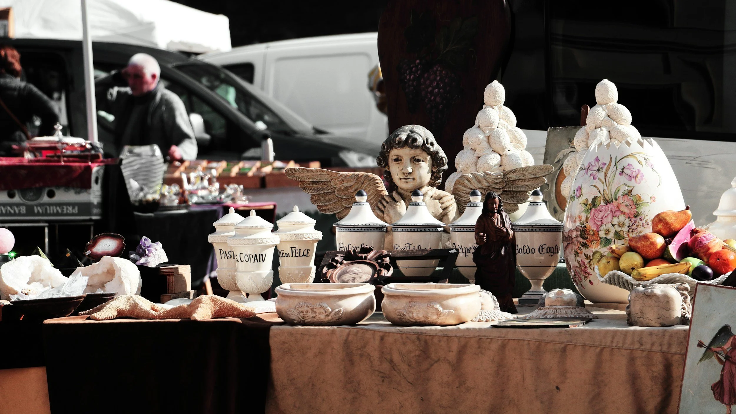 Ceramics and other items for sale at a garage sale.