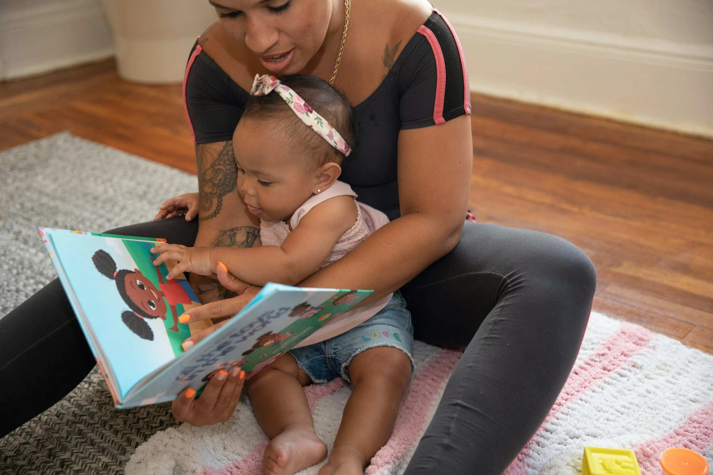 Mother and baby looking a children's picture book.