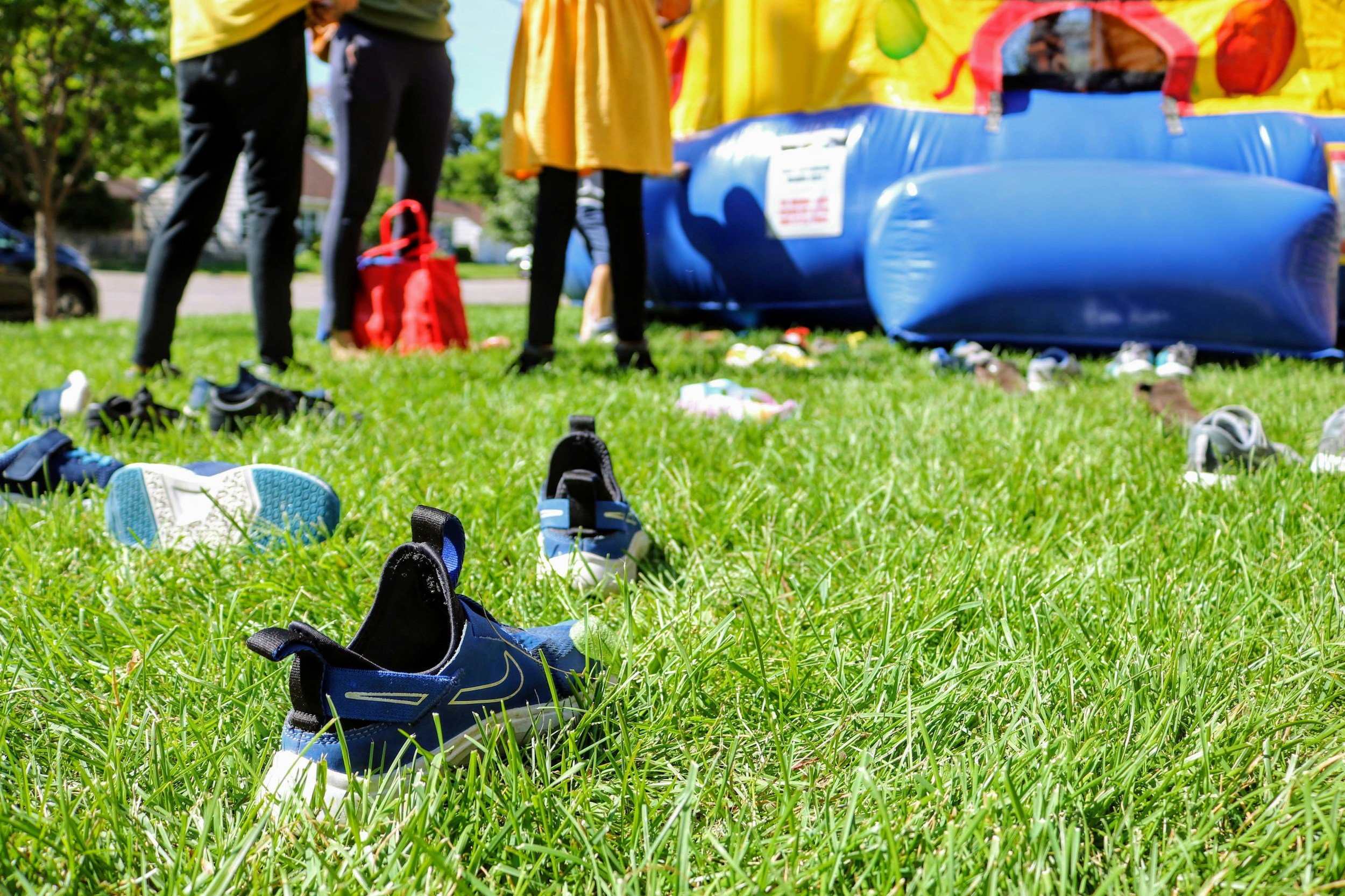 sneakers in front of bounce house at community festival.