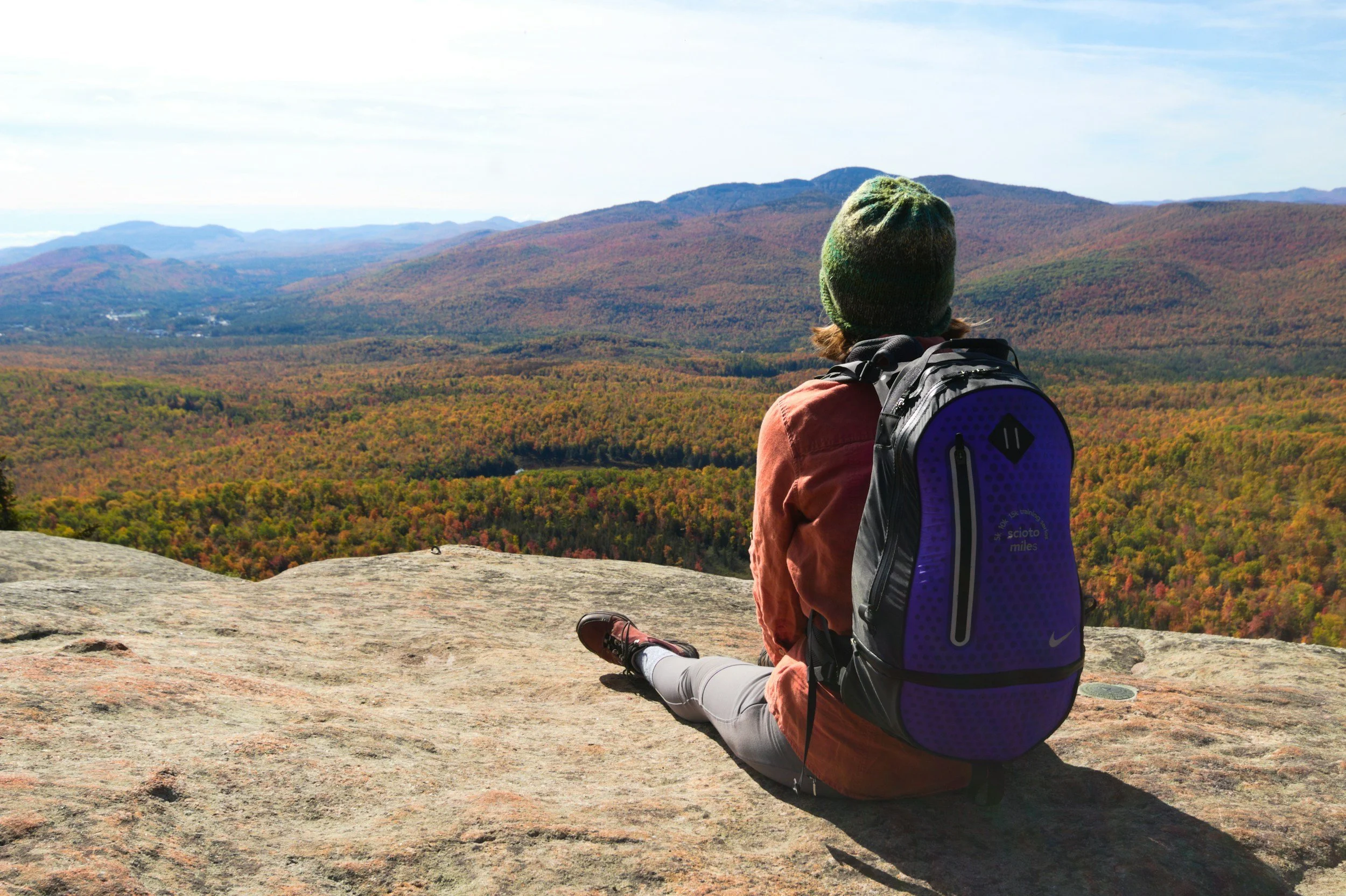 Hiker experiencing a view of the Adirondack Park in the fall.