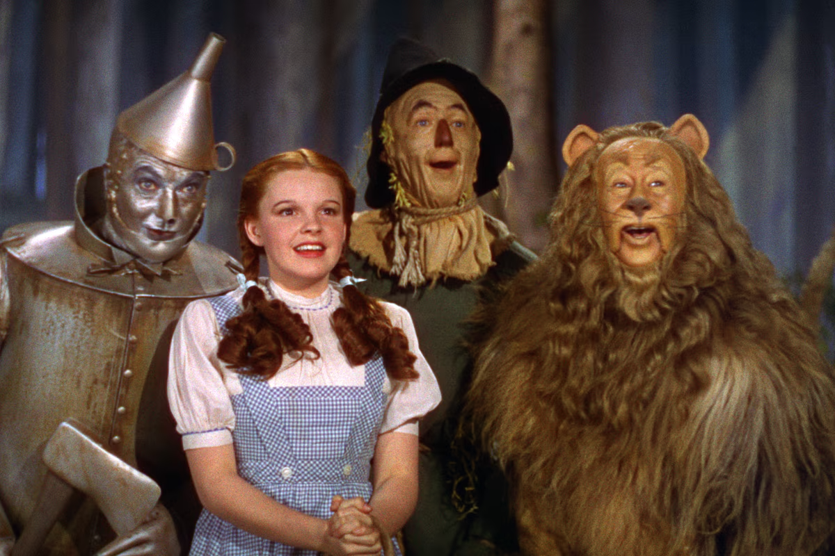 Cast of the Wizard of Oz, including the Tin Man, Dorothy, Scarecrow, and Cowardly Lion.
