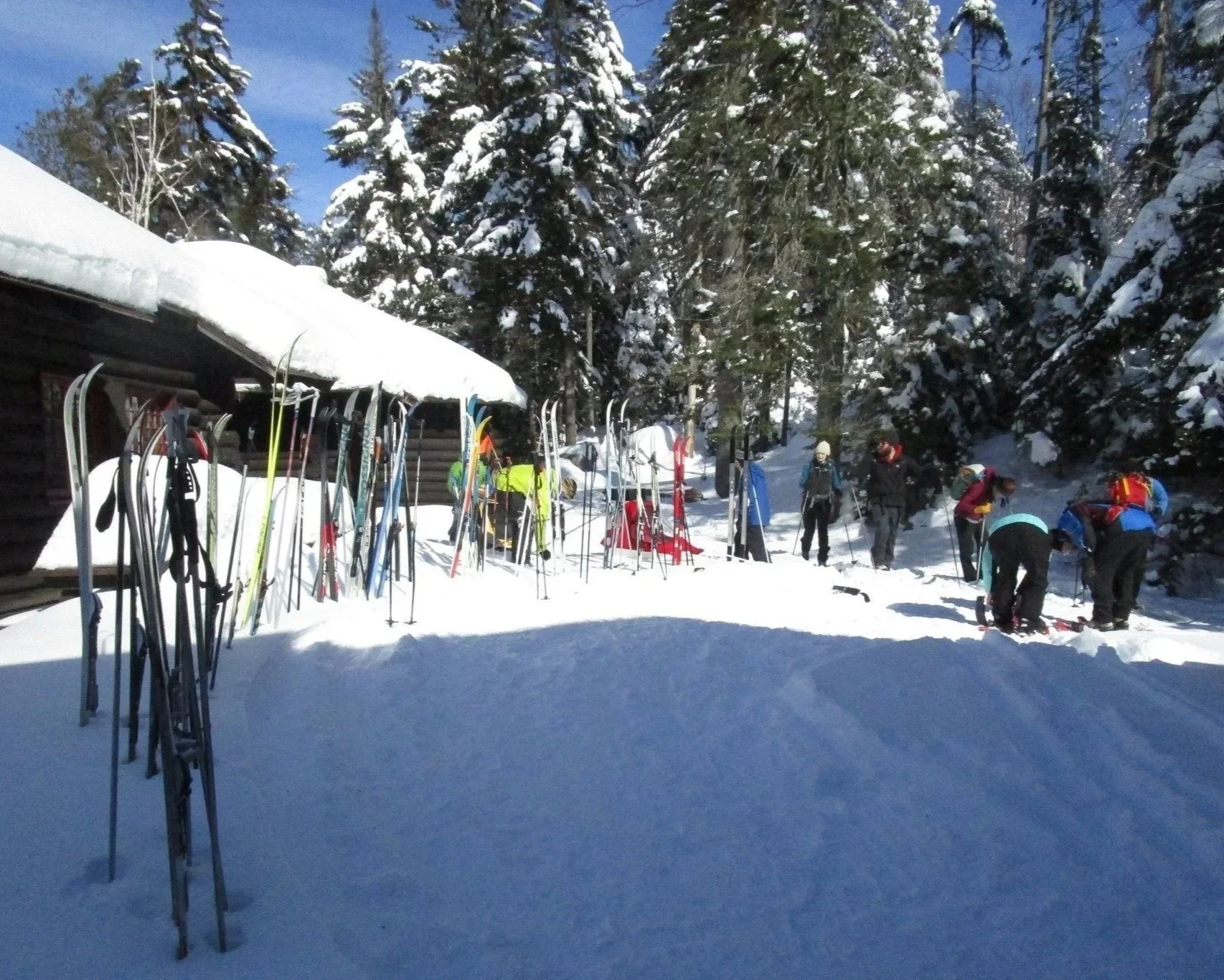 Cross country skiers at Great Camp Santanoni on a brilliant winter day.