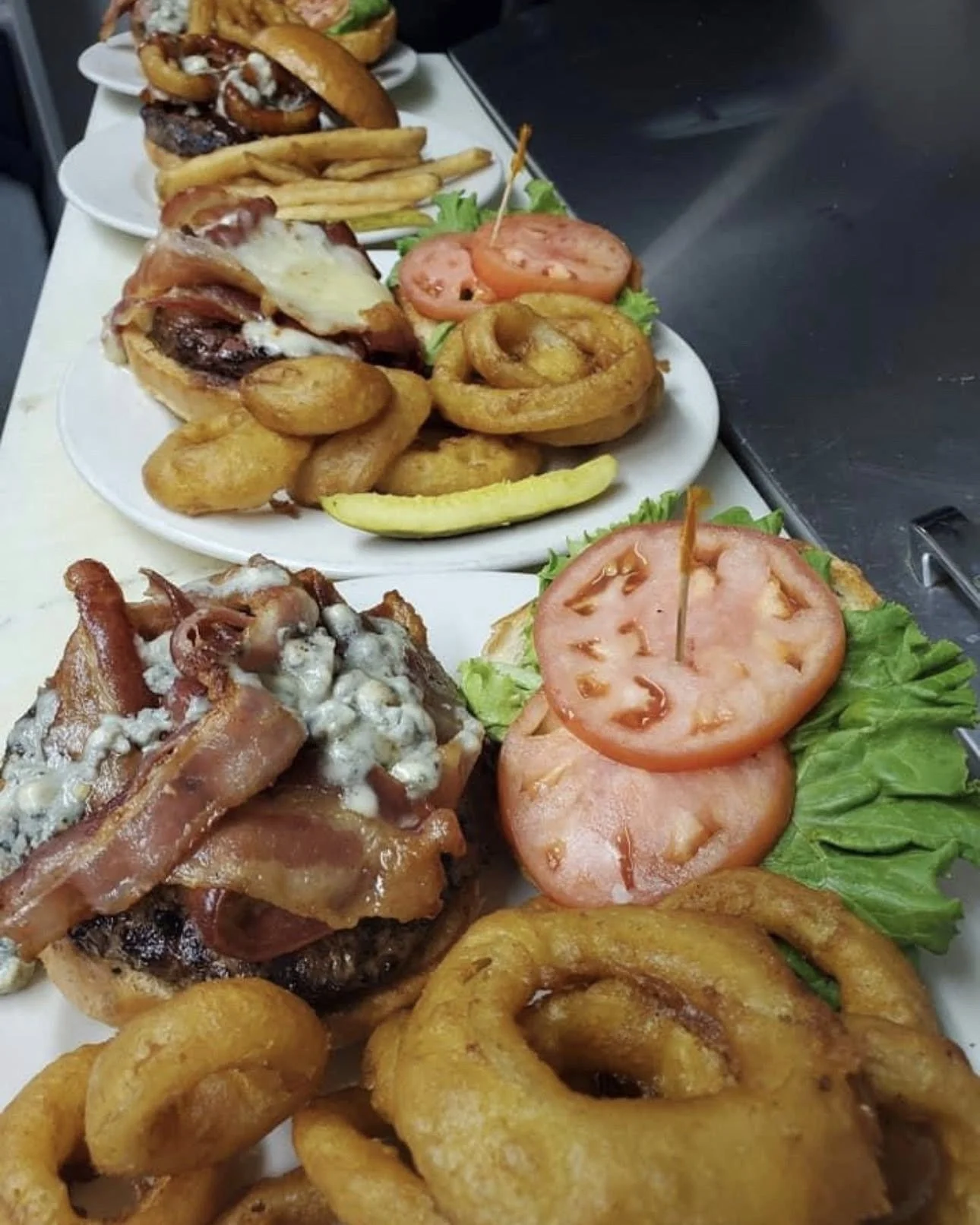 Hamburgers with fries and onion rings served at Long Horn in Lake Luzern.