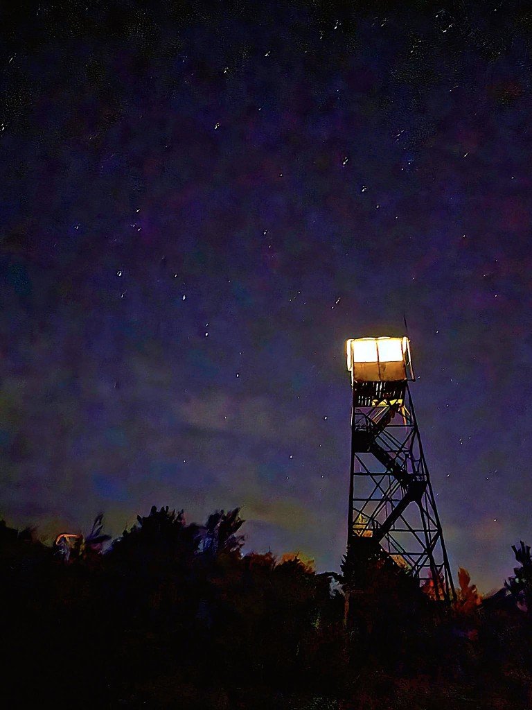 Fire tower lit up on Poke O Moonshine in the Adirondack Park.