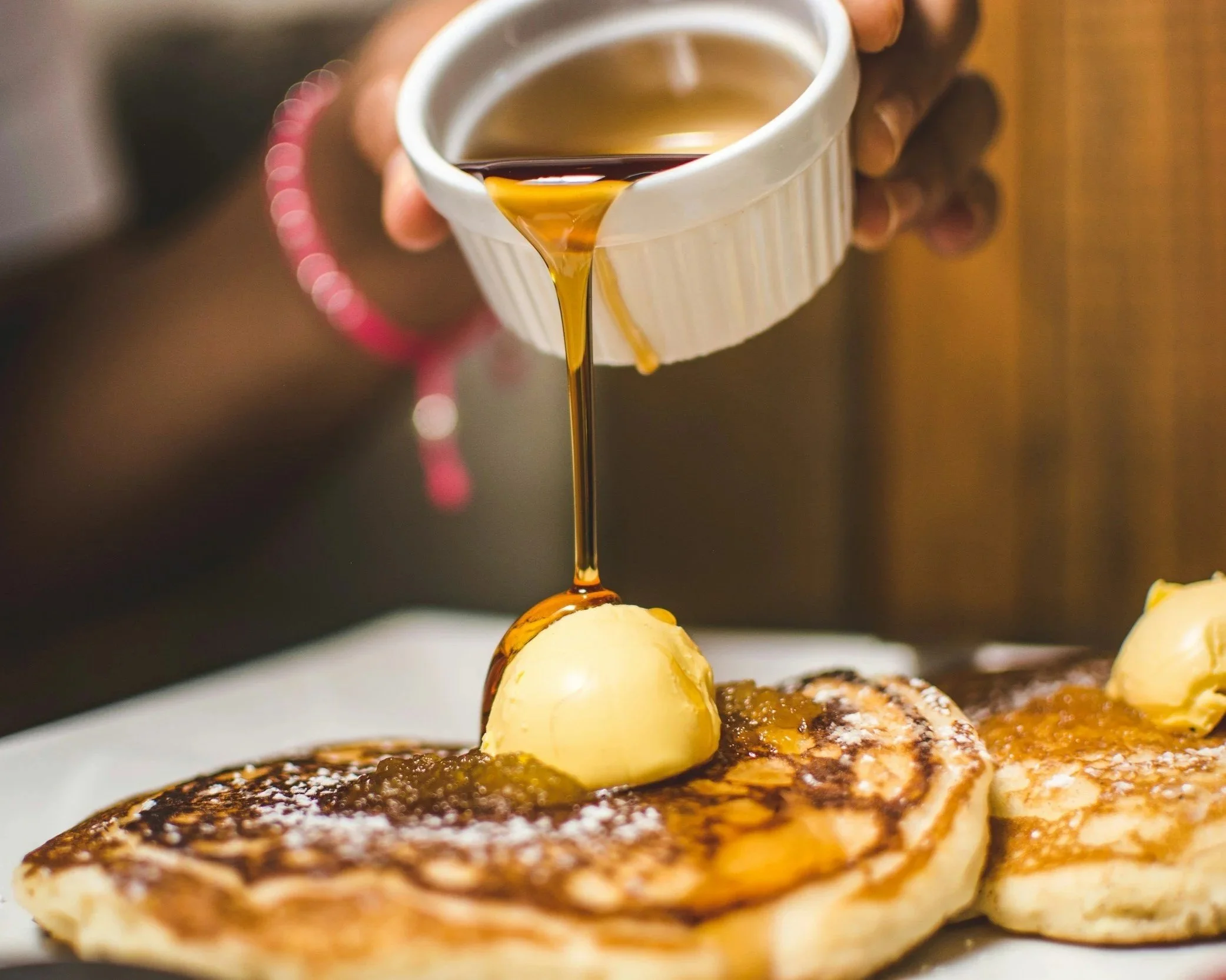 Pure 100% adirondack maple syrup poured over buttered pancakes.