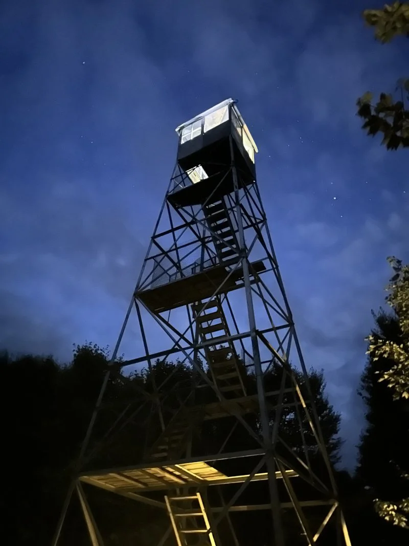 Adirondack fire tower on Cathedral Rock lit up on Labor Day Weekend.