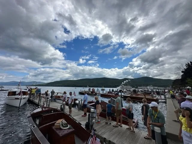 Lake George Village Town Docks with vintage boats on display.