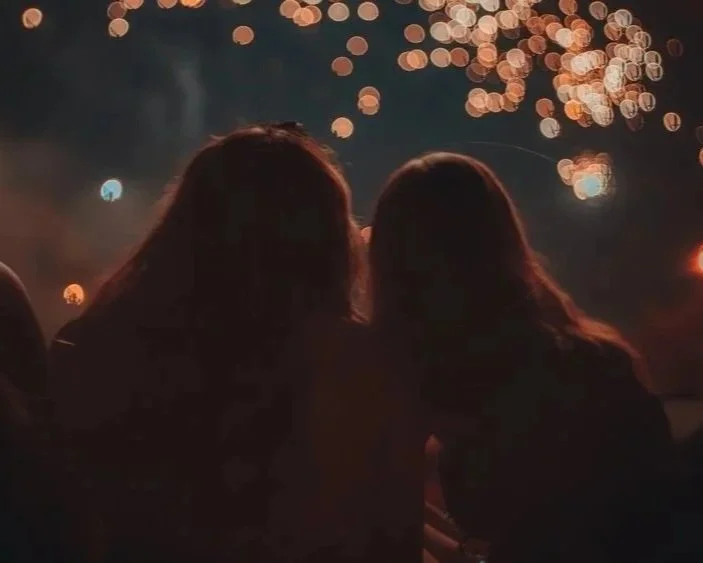 Girls enjoying 4th of July firework show.
