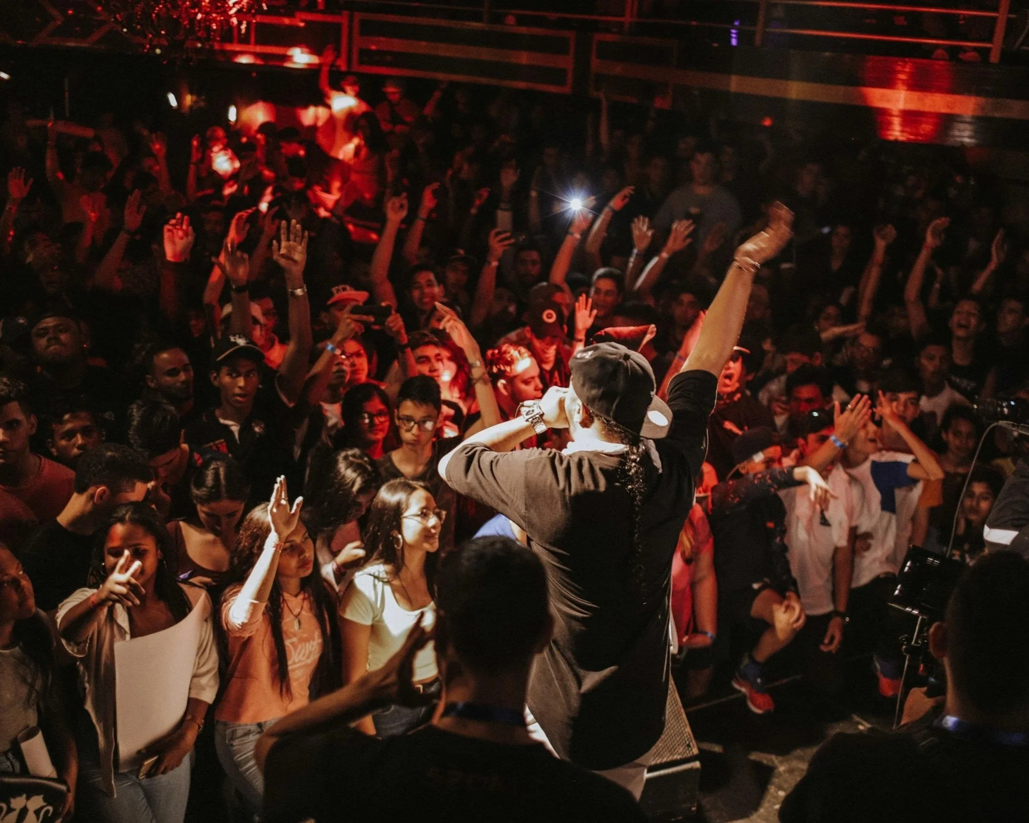 Crowd reacting to a live comedy performance.
