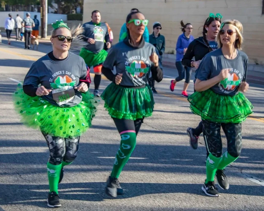 Racers in St. Patrick's Day costumes run in Glens Falls Shamrock Shuffle.