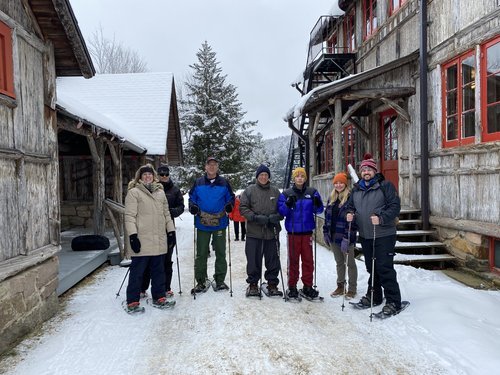 A group of people snowshoeing at Great Camp Sagamore's winter snow days.