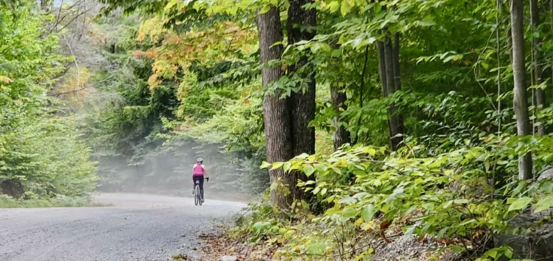 A woman riding on a gravel road during BikeADK's annual biking event, Handlebarley.