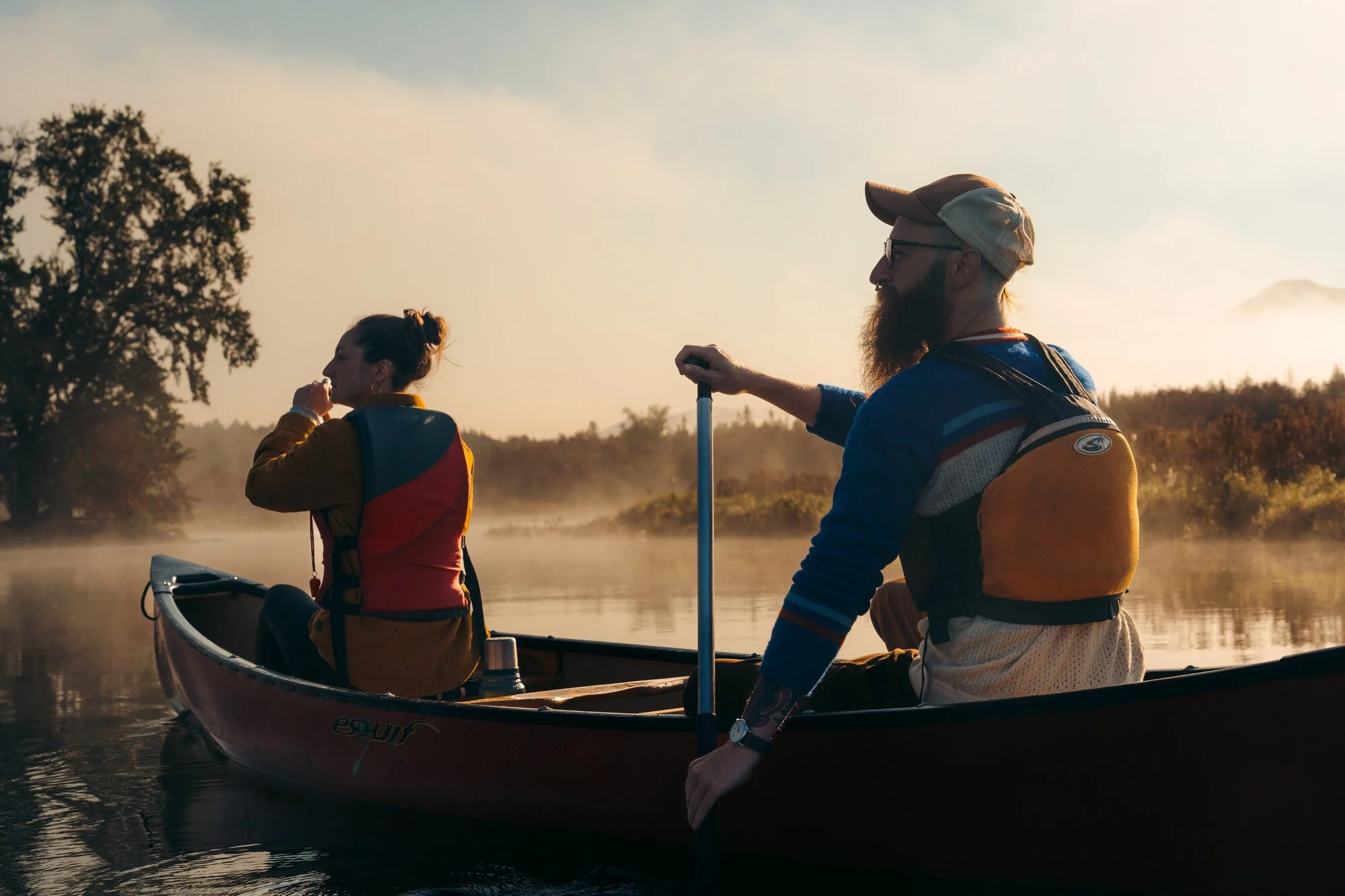 Canoers paddling on Saranac Lake in the Adirondacks.