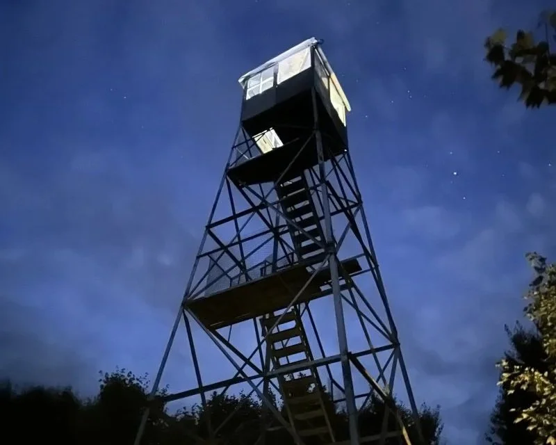 Adirondack fire tower lit up at night over Labor Day Weekend.