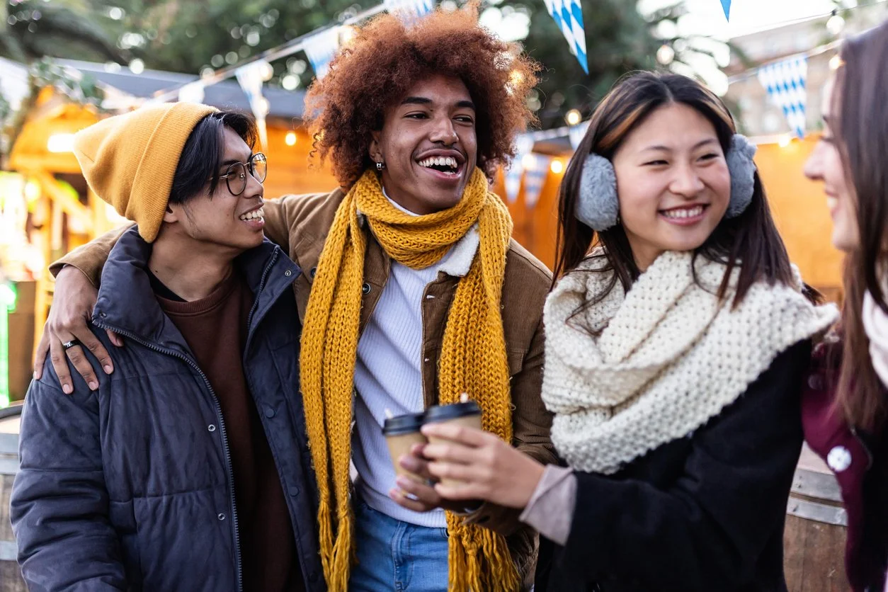 Three friends enjoying a live music festival in April.