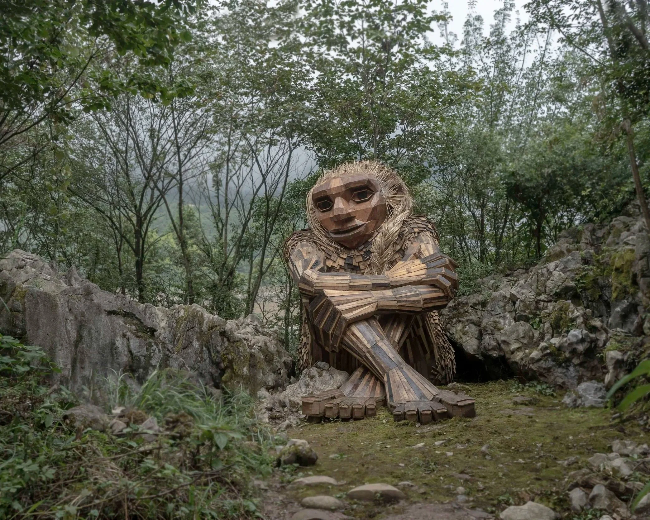 Thomas Dambo troll in the woods.