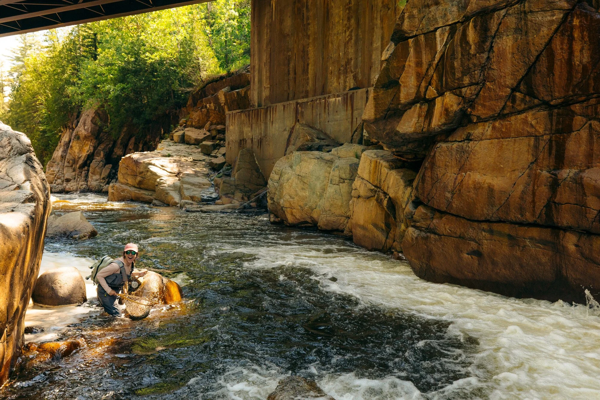 Woman fly fishing the flume on the Ausable river near Whiteface in the Adirondacks.