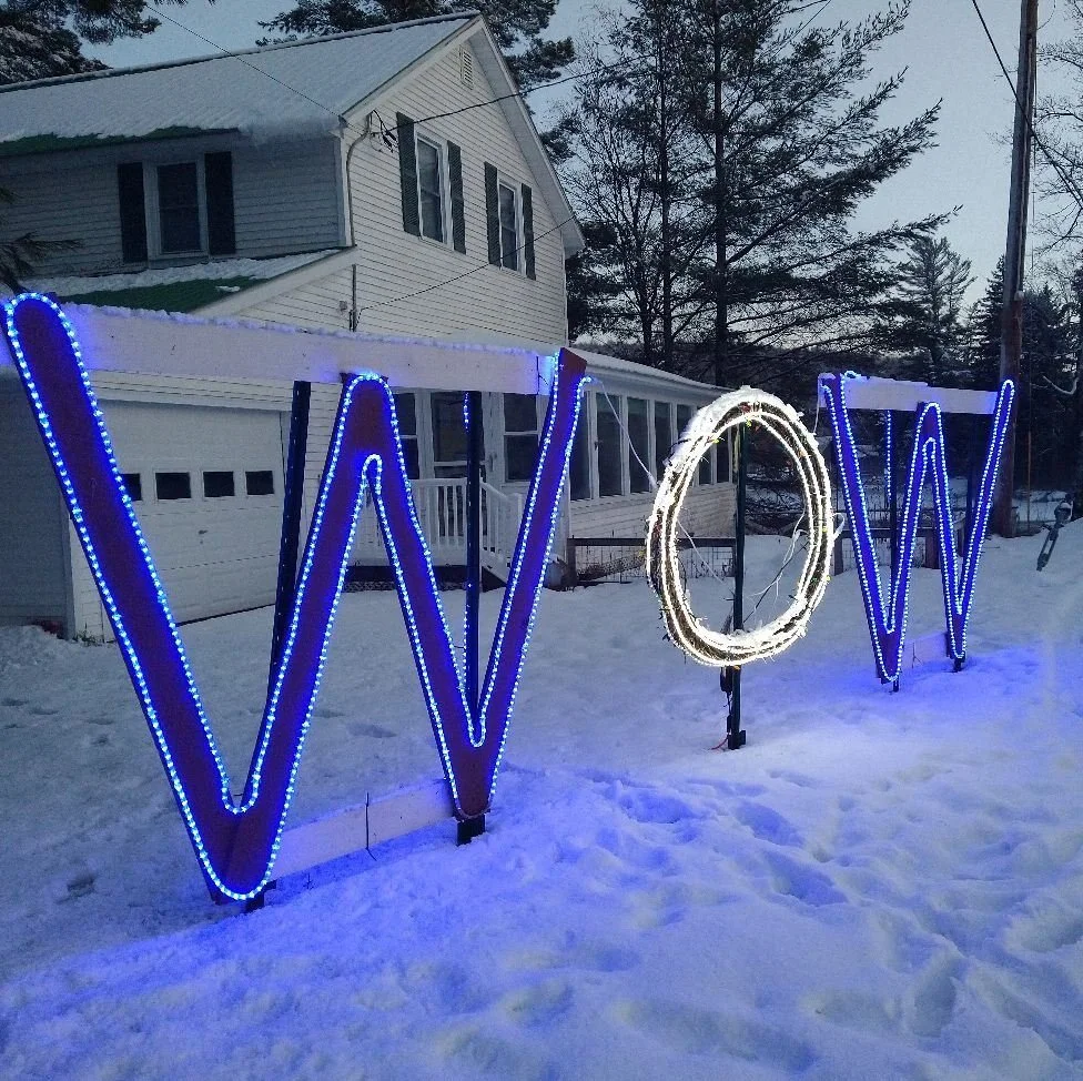 Illuminated sign promoting the Adirondack Winter WhiteOut Weekend.