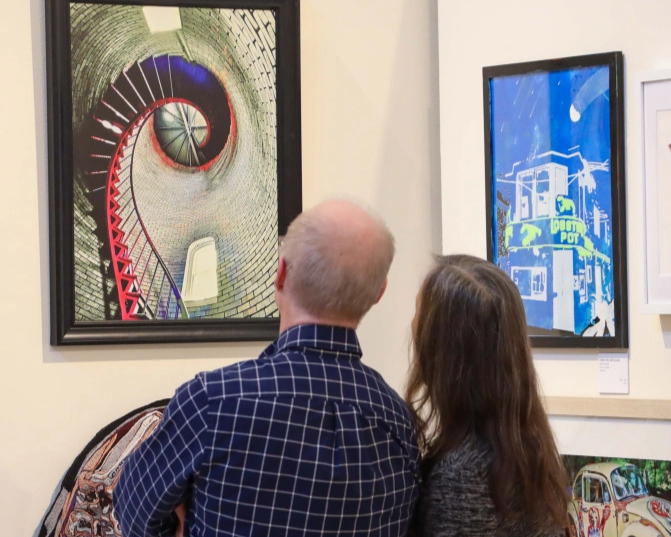 Visitors admiring local Adirondack art in Old Forge.