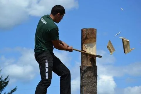 Lumberjack chopping wood with an axe at Stony Creek Mountain Days.