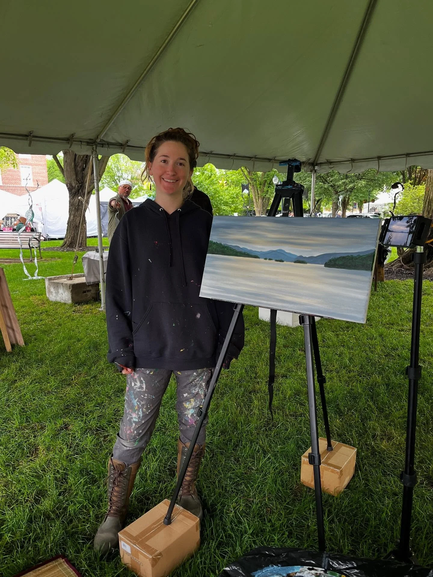 Woman painter with Adirondack landscape at Glens Falls June Arts Festival