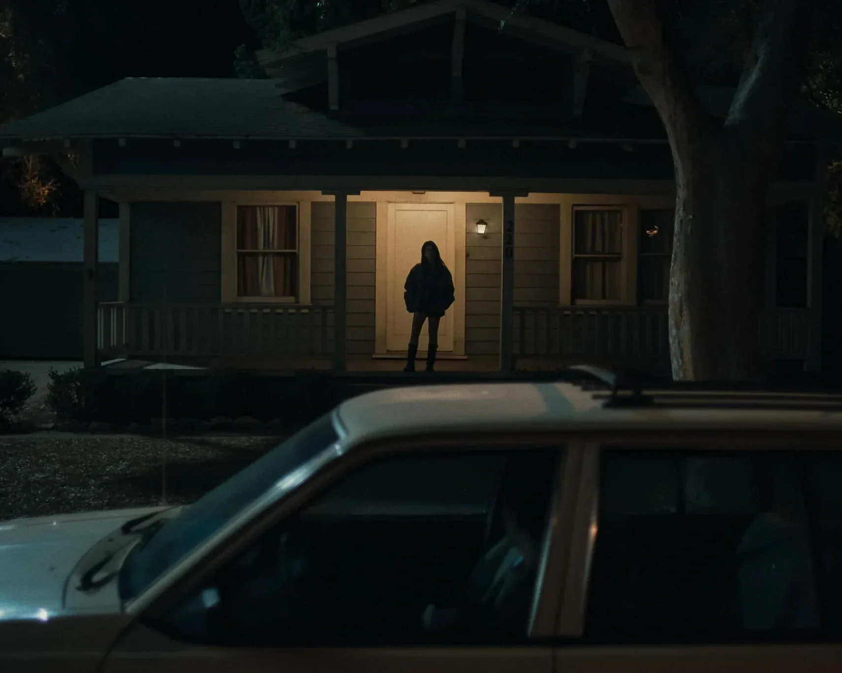 Silhouette of girl on porch in the horror movie "obsession"