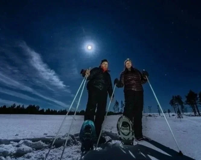 Snowshoeing under a full moon in winter.