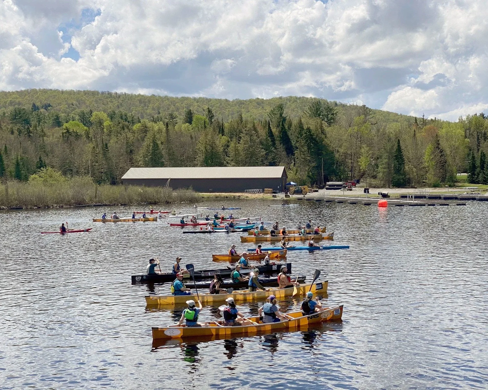 Canoes and Kayaks race on Saranac Lake during the annual 'Round the Mountain race