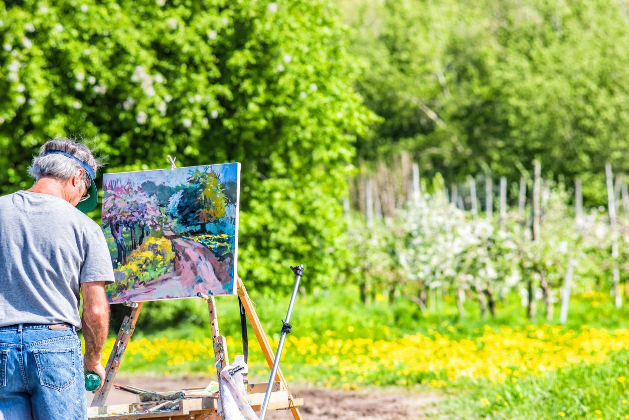 Artist painting outdoors at a Plein Air event.