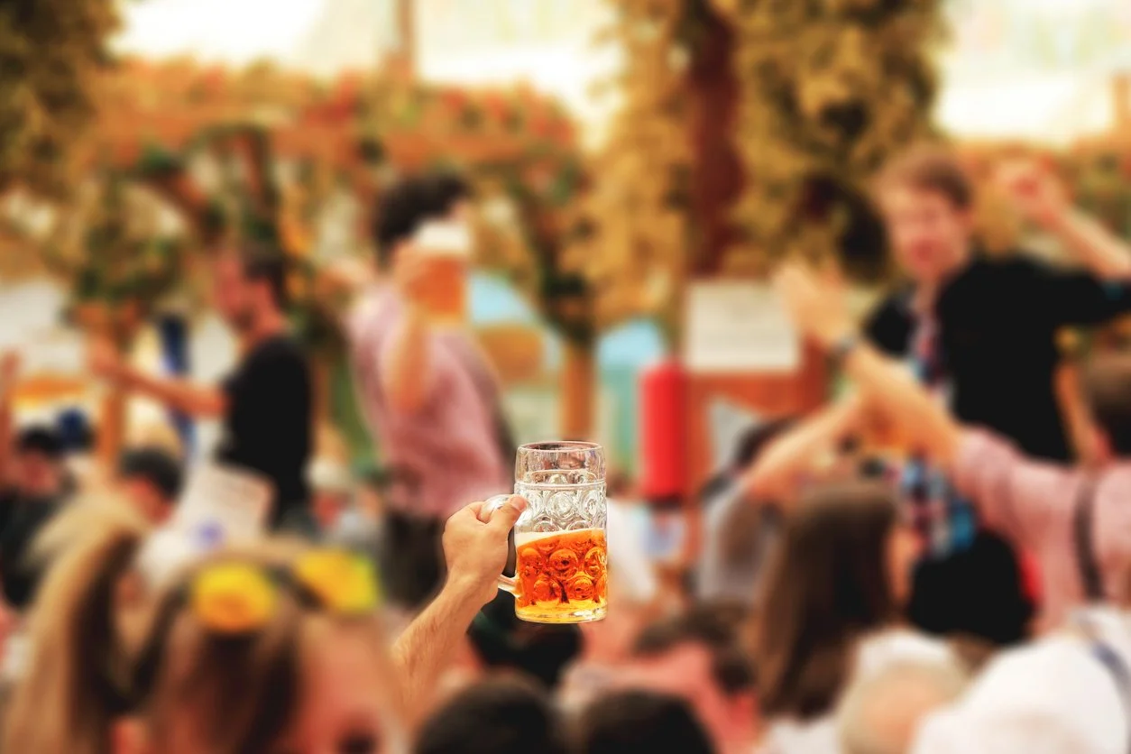 People hoisting steins of beer at Old Forge's Oktoberfest in the Adirondacks.