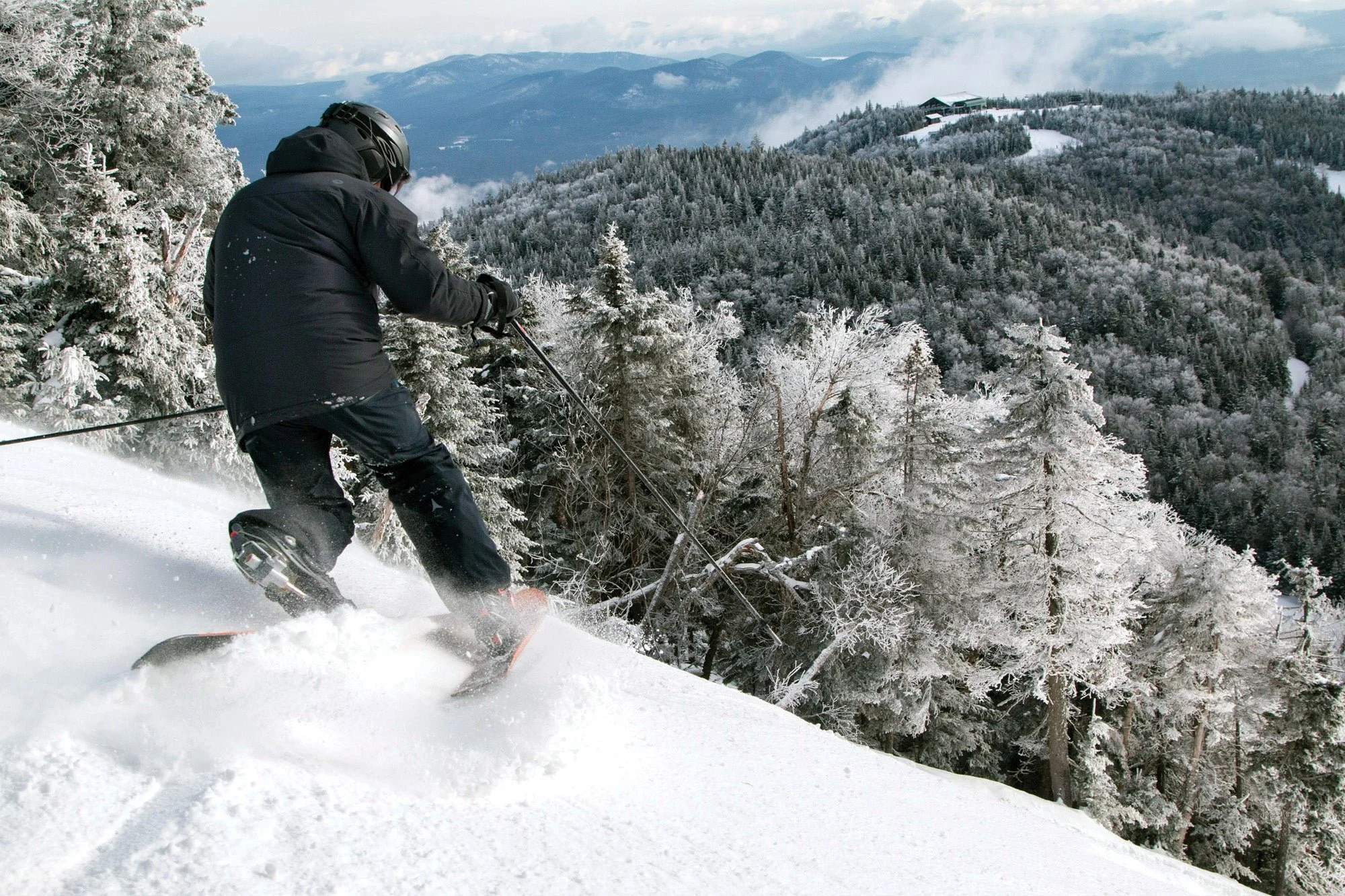 Skier making fresh tracks in the powder at Gore Mountain in the Adirondack Park in Upstate New York.