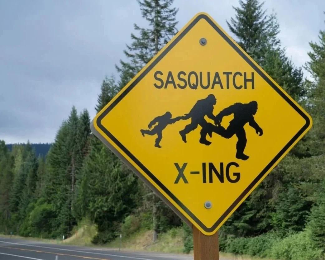 Road sign indicating sasquatch crossing.