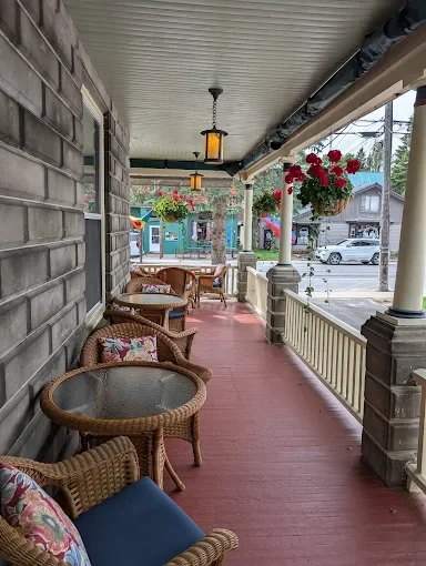 Enjoying a cocktail outdoors on The Waiting Room's wrap-around porch.