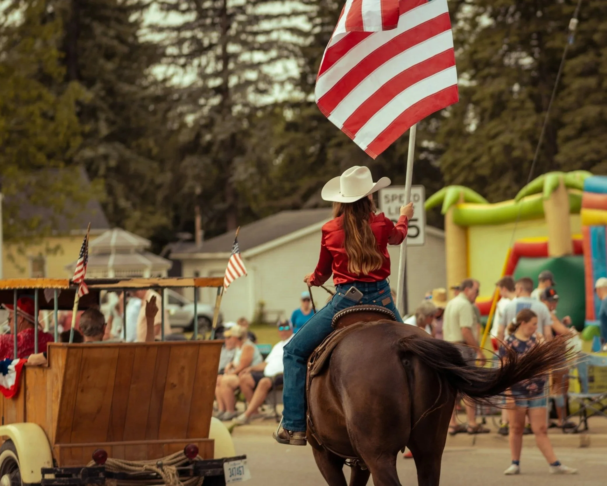 Girl on a horse in a 4th of July parade.
