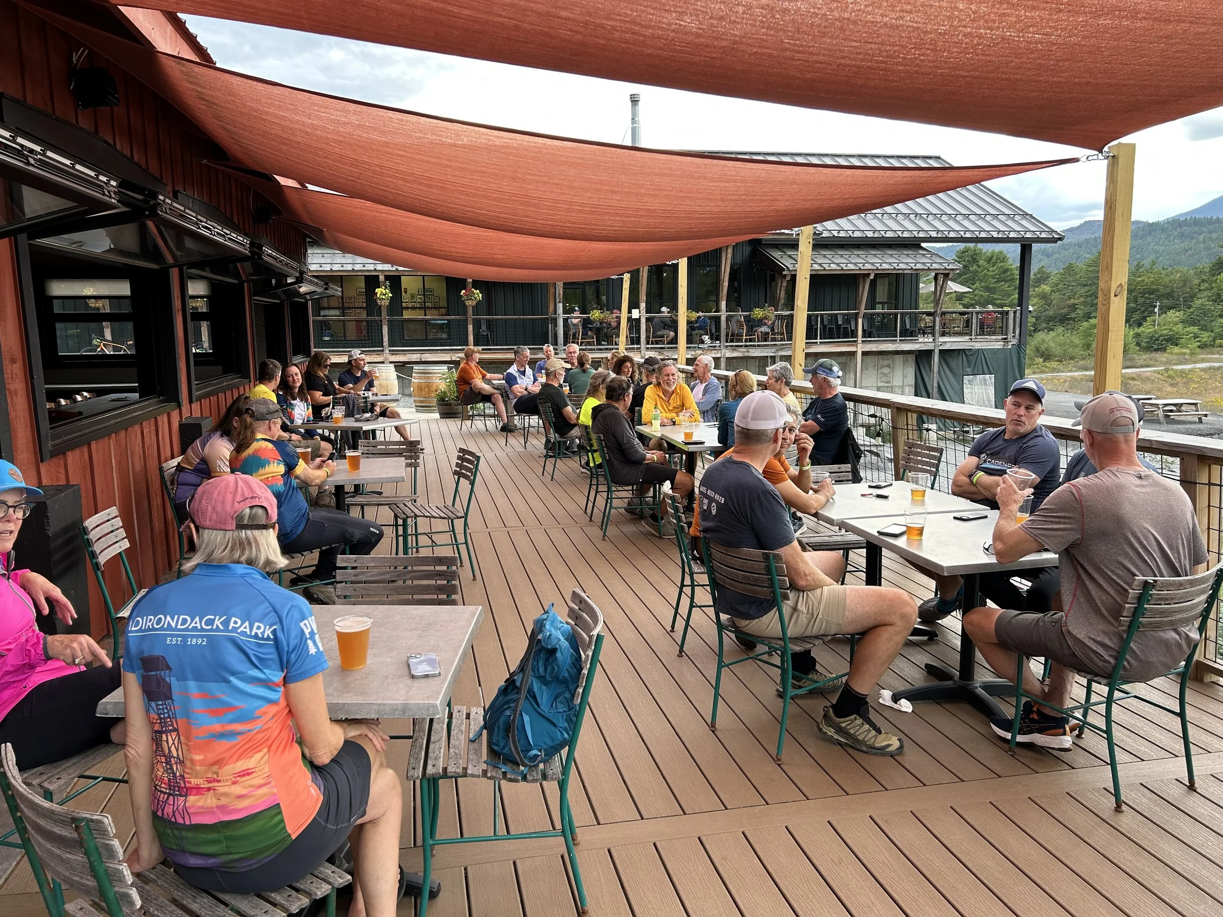 People enjoying pizza at Paradox Brewery's deck.