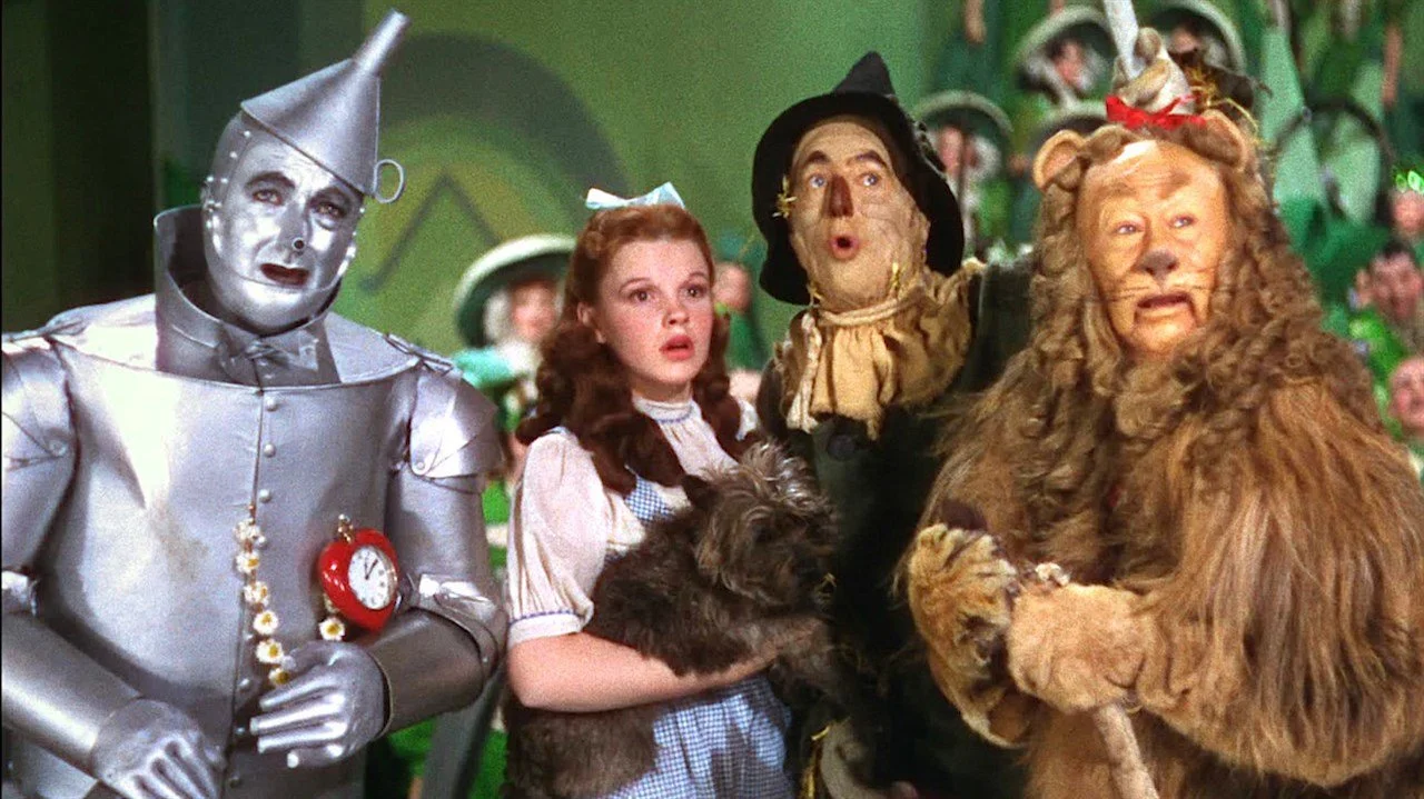 The cast of the wizard of oz in the emerald city.
