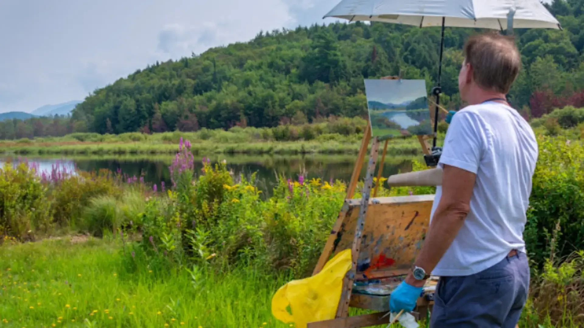 Painter capturing a mountain lake in the Adirondack Plein Air Festival.