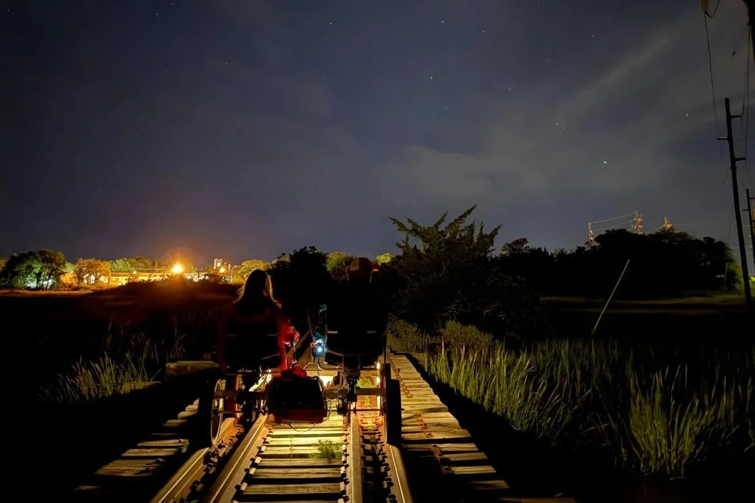 People riding the rail trail at night.