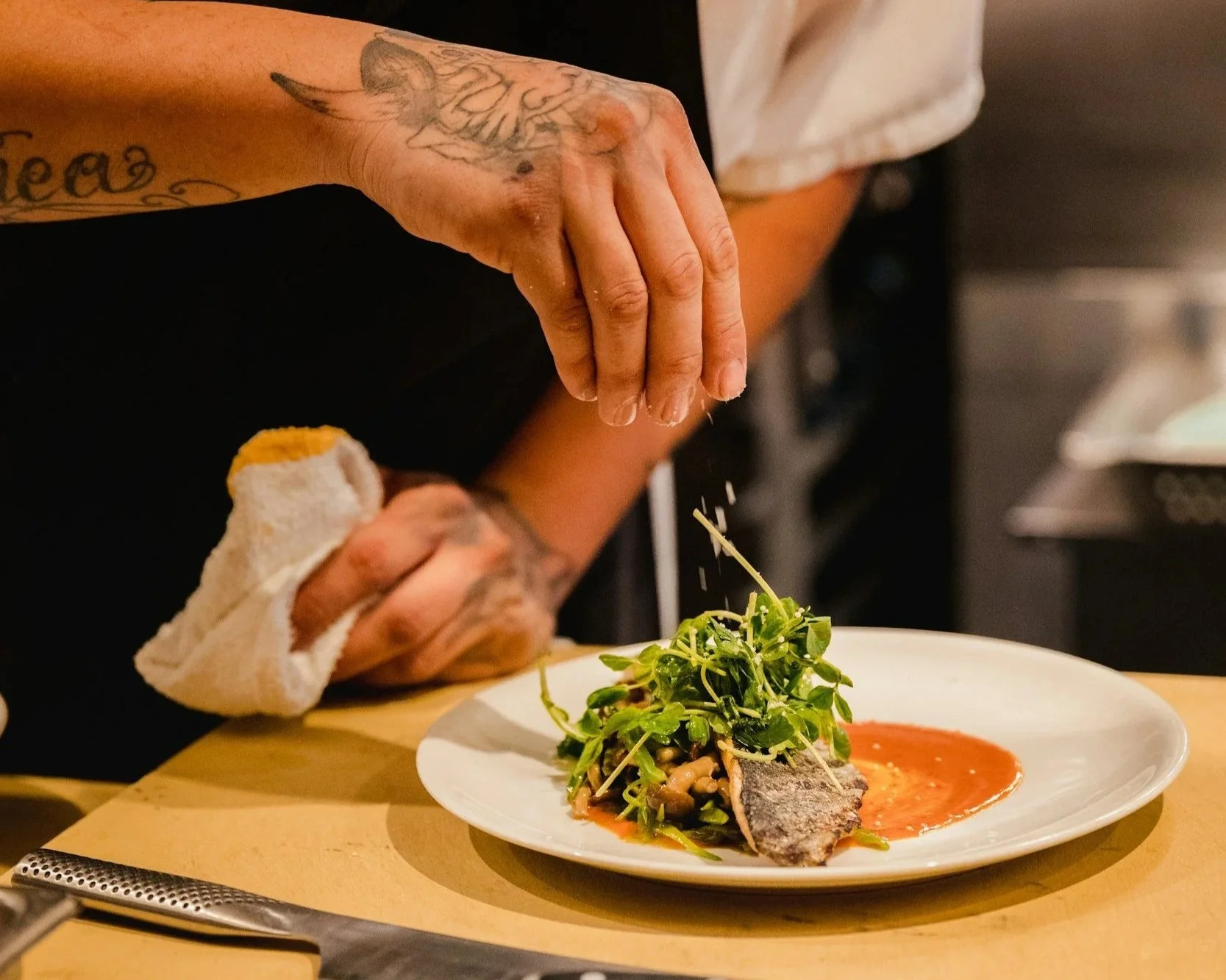 Chef seasoning food.