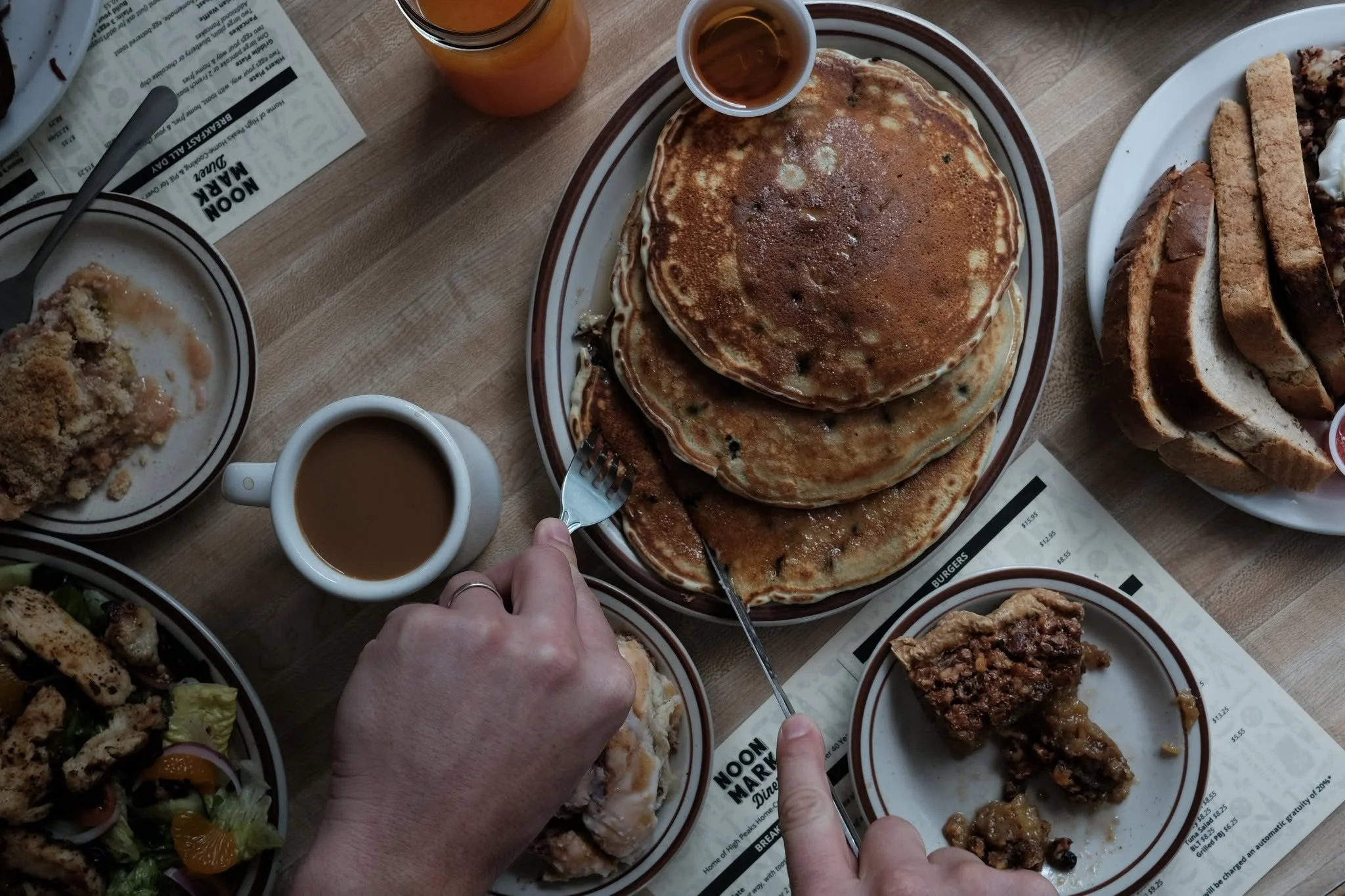 Pancakes, oatmeal, pie and other food items on a table at Noon Mark Diner.