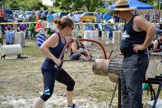 woman sawing a log in a logging competition in Stony Creek.
