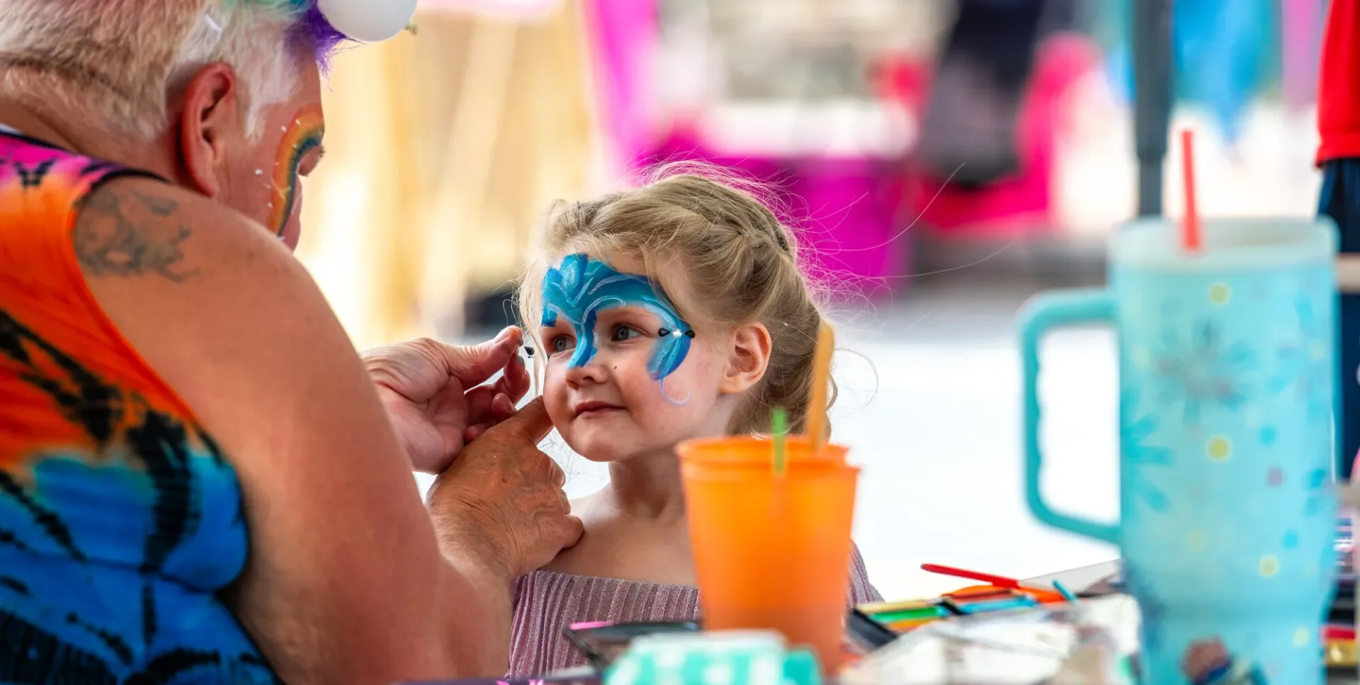 Young girl getting her face painted at Tupper Lakes Party on Park