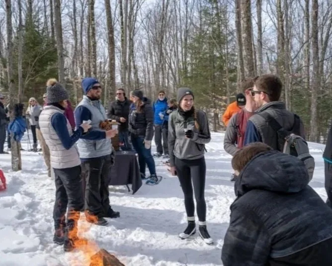 Tupper Lake Brewski participants enjoying craft beverages on XC ski trails.