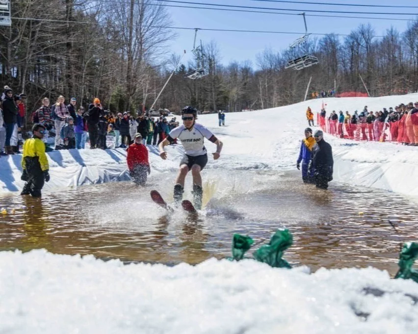 Competitor skimming a cross a pond at Whiteface Mountain in Lake Placid.