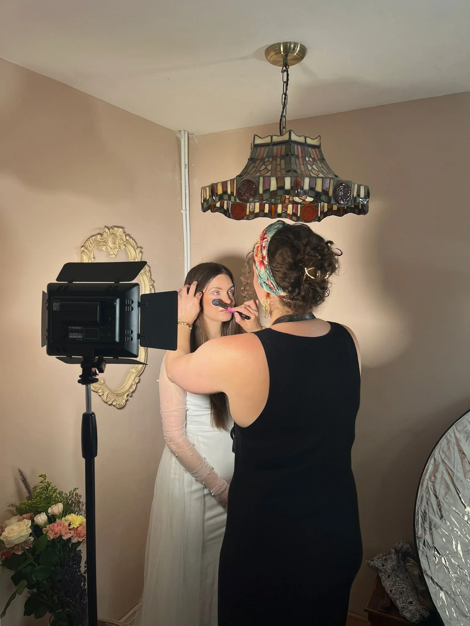 Professional makeup artist and photographer Sinéad Boomsma applying makeup on model for bridal inspired photoshoot collaboration.