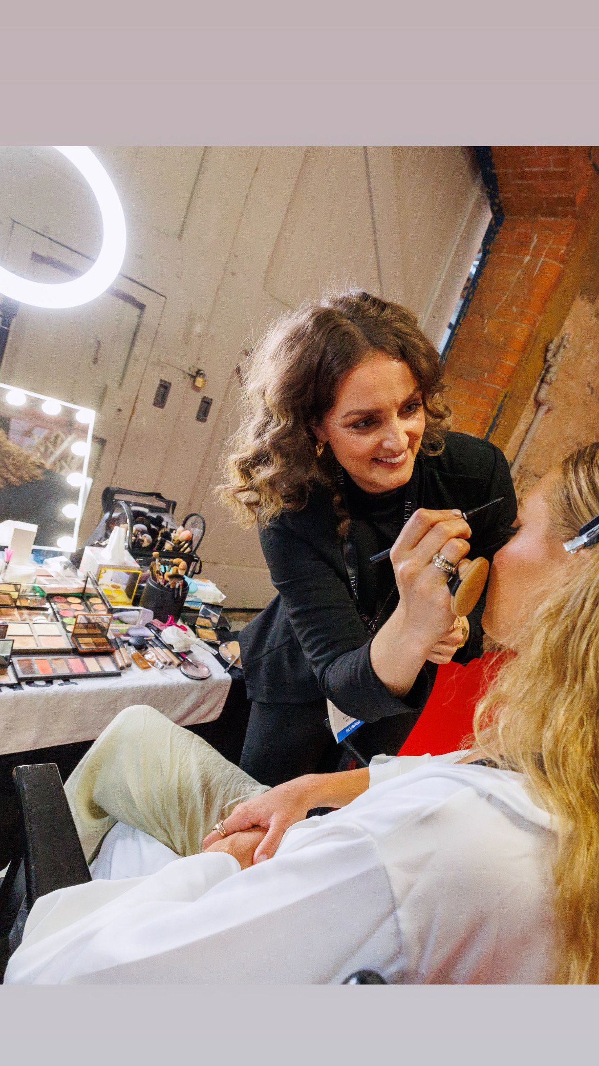 Makeup artist applying makeup to a model for the WedDub event in the RDS Dublin.