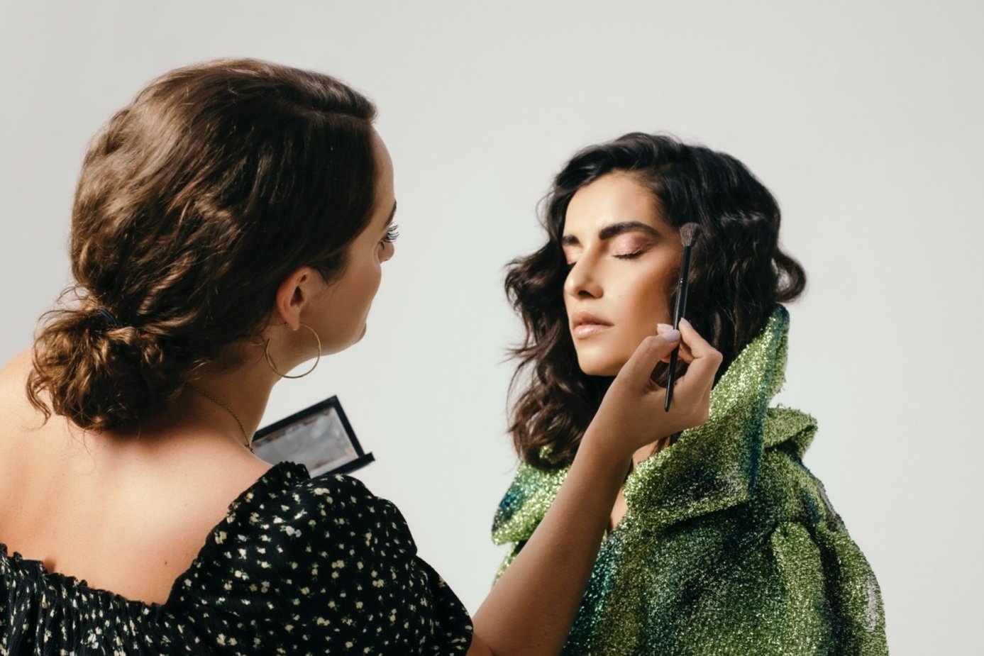 Makeup artist applying makeup to a model for a professional shoot in Dubai., UAE.