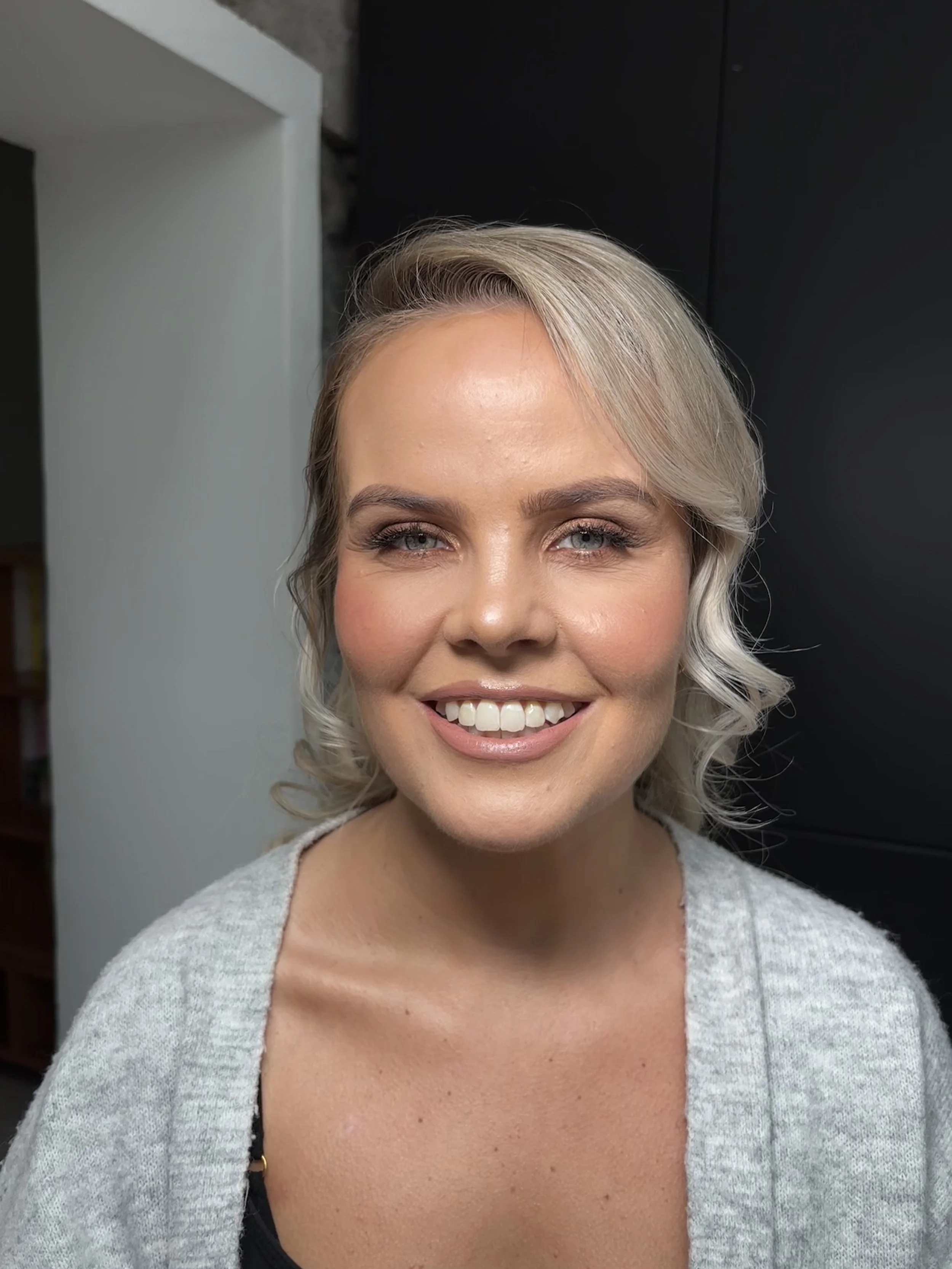 A beautiful wedding guest posing for a photo. Makeup by Limerick based bridal and event makeup artist beauty by booms. .