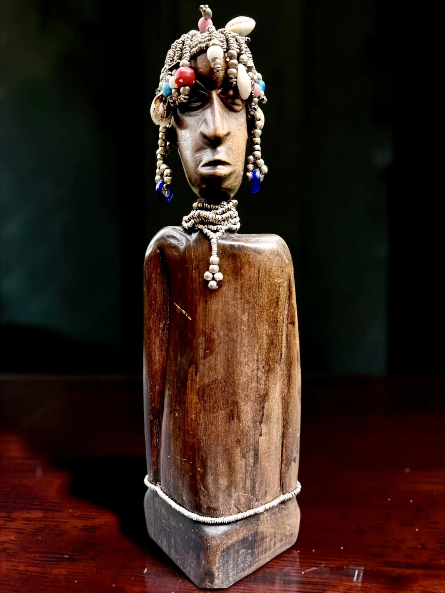 Vintage Cameroonian Namji Carved Wood Figure With Cowrie Shells and Metal Beads
Attributed to the Namji people of Cameroon, circa 1980s–1990s, individually hand-carved from a single solid block of wood with visible tool marks and natural variations, 